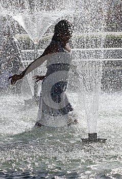 Kids play in a water of a fountain on a sunny summer day during summer break in Sofia, Bulgaria Ã¢â¬â june 15, 2012. Sunny weather c